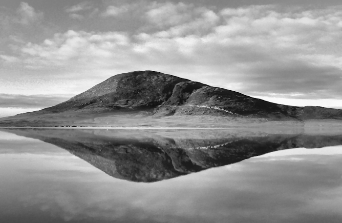 A hill, reflected in the clear, cold, still water. Isle of Harris, Scotland.