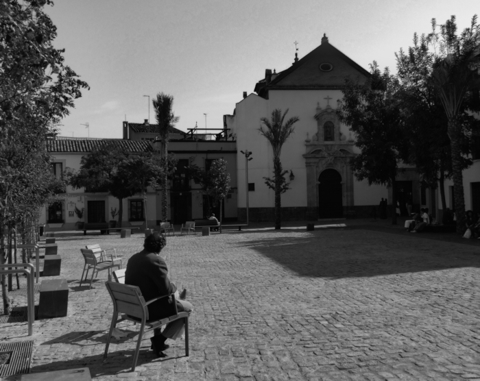 A man looking towards a church in Cordoba, Spain